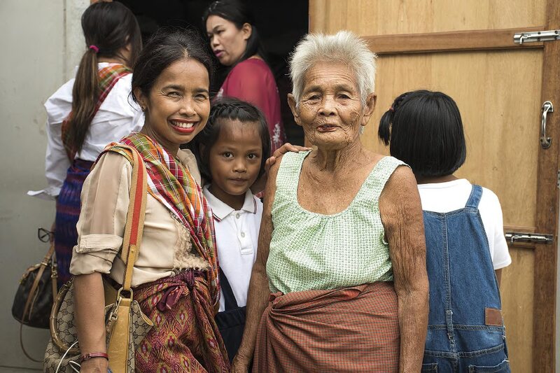 Woman smiling with child and elderly woman